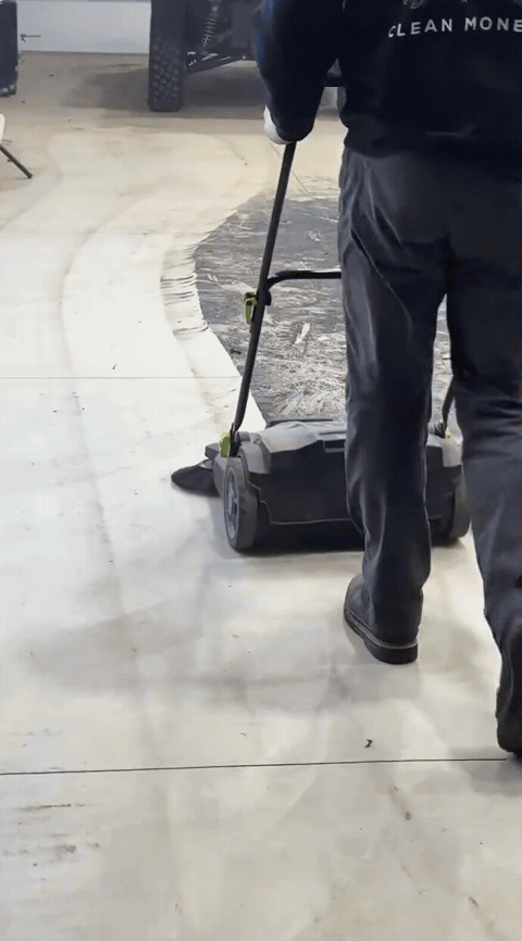 Sweeper clearing a dusty shop floor in one pass